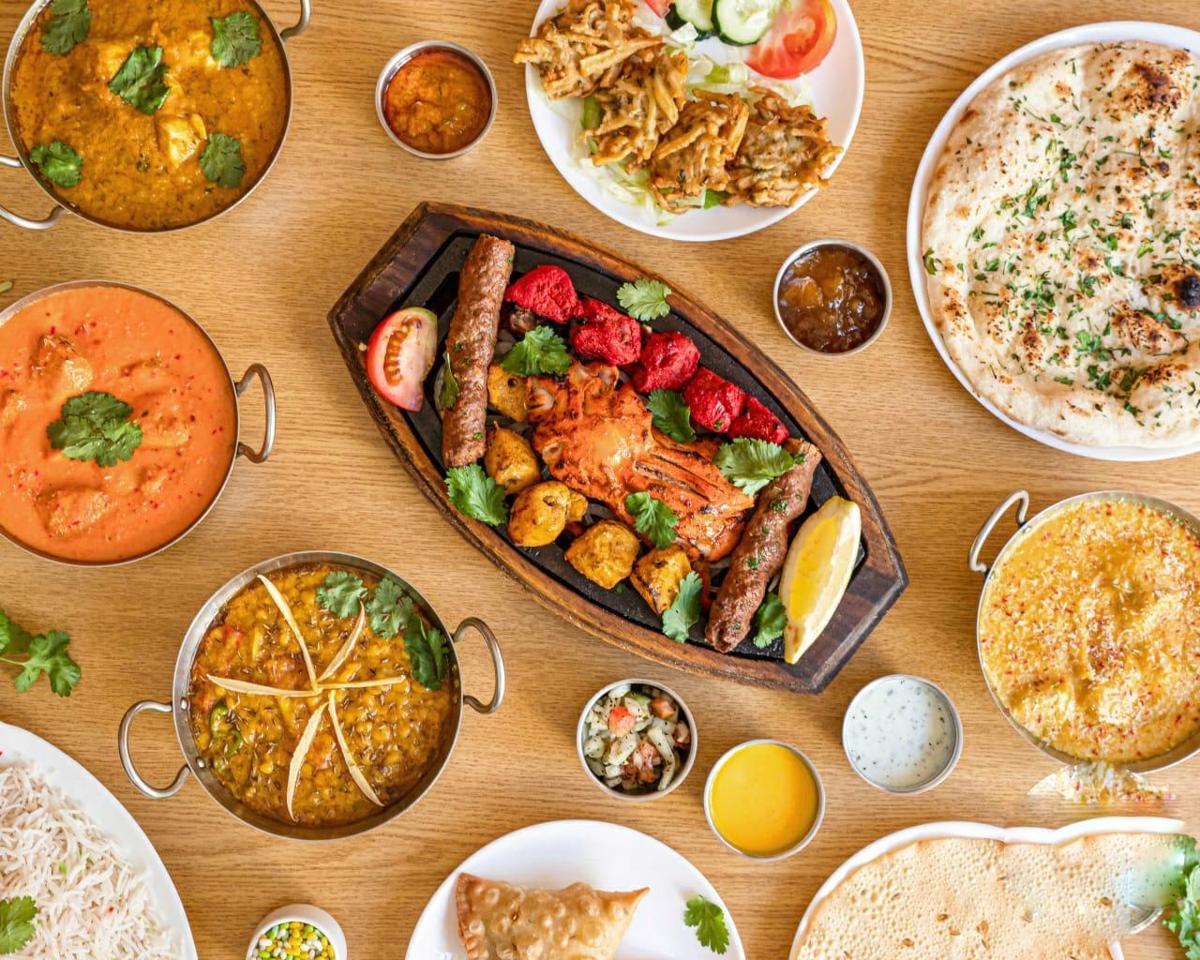 A spread of curries, naan and grilled dishes